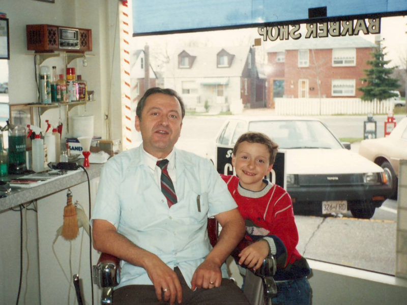 Young Chris Grafos with his father in the family barber shop
